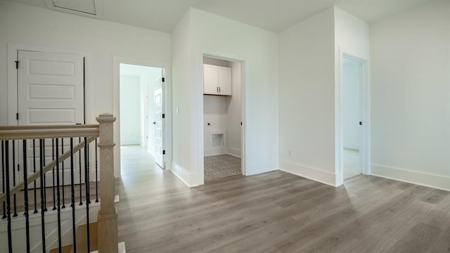 1514 Gatekeeper Ter, Marietta, GA 30066 - hallway with an upstairs landing, light wood-type flooring, and baseboards