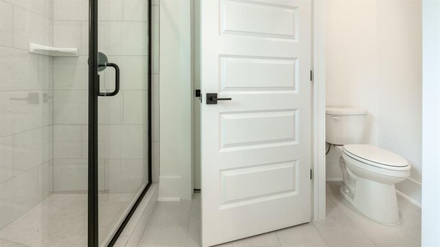 1514 Gatekeeper Ter, Marietta, GA 30066 - full bathroom with tile patterned flooring, toilet, a shower stall, and baseboards