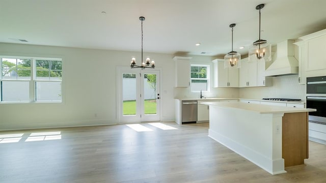1514 Gatekeeper Ter, Marietta, GA 30066 - kitchen with appliances with stainless steel finishes, custom range hood, a chandelier, light countertops, and a center island