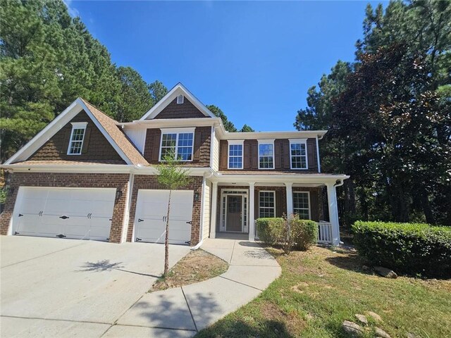 view of front of property with covered porch and a garage