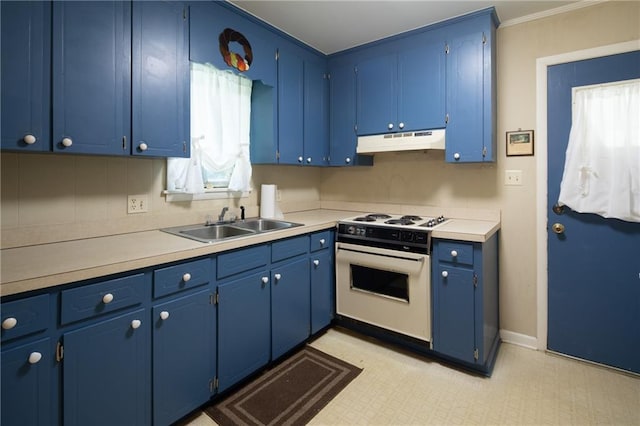 kitchen with gas range gas stove, sink, blue cabinetry, and light tile patterned floors