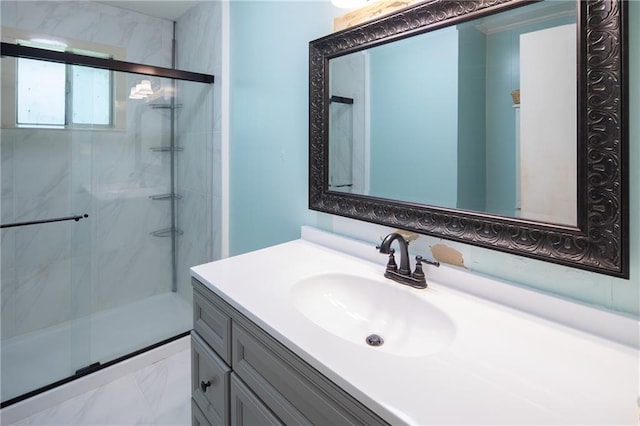 bathroom with a shower with shower door and vanity