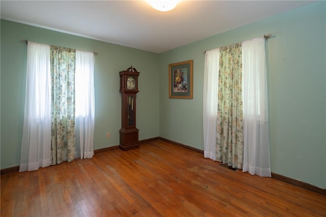 spare room with hardwood / wood-style flooring