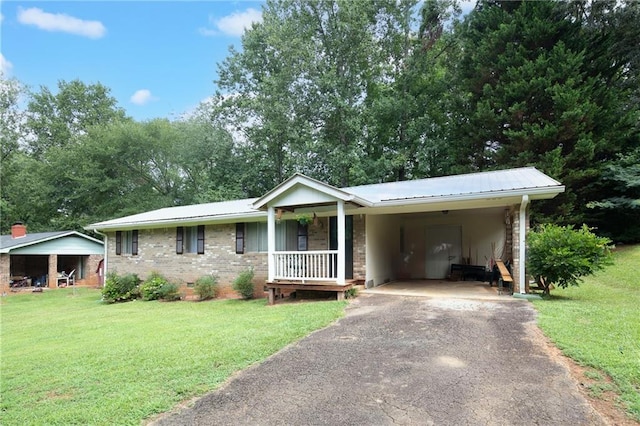 ranch-style home featuring a carport and a front yard