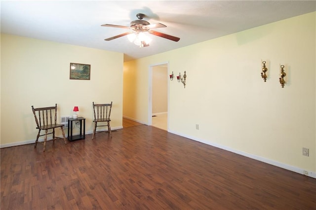 empty room with dark wood-type flooring and ceiling fan