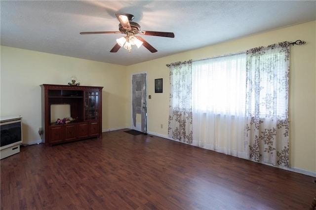 living room featuring ceiling fan and dark wood-type flooring