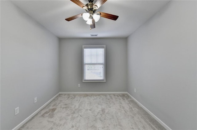 spare room featuring ceiling fan, carpet floors, visible vents, and baseboards