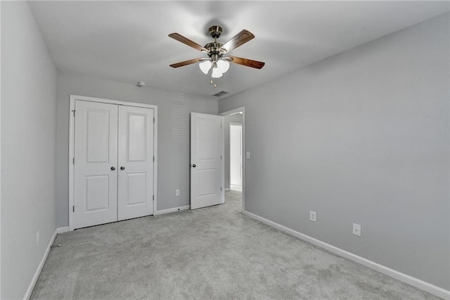 unfurnished bedroom featuring a closet, carpet flooring, visible vents, and baseboards