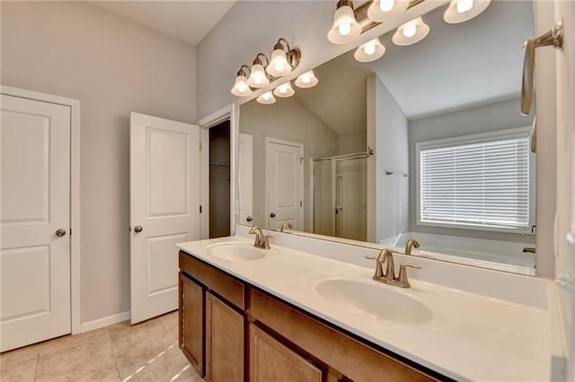 full bathroom featuring double vanity, tile patterned floors, a sink, and a shower stall