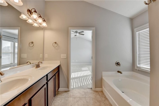 bathroom featuring double vanity, a garden tub, a sink, and tile patterned floors