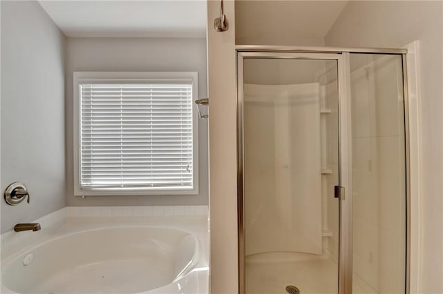 full bathroom featuring a shower stall and a bath