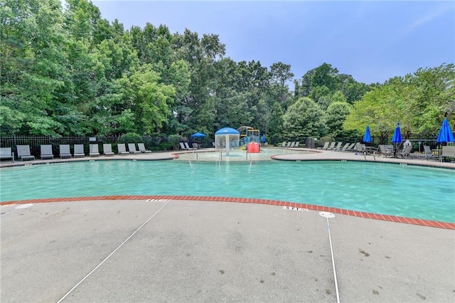 pool featuring a patio and fence