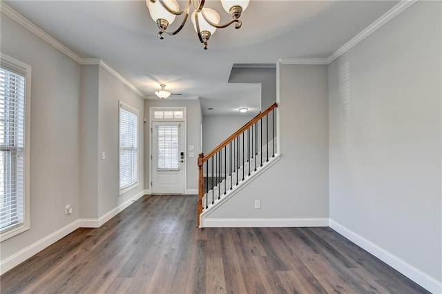 entrance foyer with crown molding, stairs, baseboards, and wood finished floors