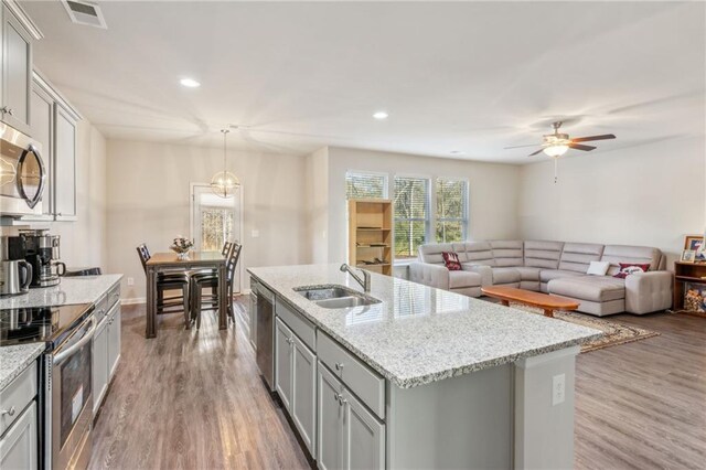 121 Jim Daws, Monroe, GA 30655 - kitchen with sink, stainless steel appliances, decorative light fixtures, light hardwood / wood-style floors, and a kitchen island with sink