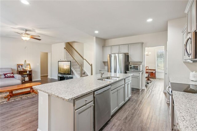 121 Jim Daws, Monroe, GA 30655 - kitchen featuring stainless steel appliances, an island with sink, gray cabinets, ceiling fan, and wood-type flooring
