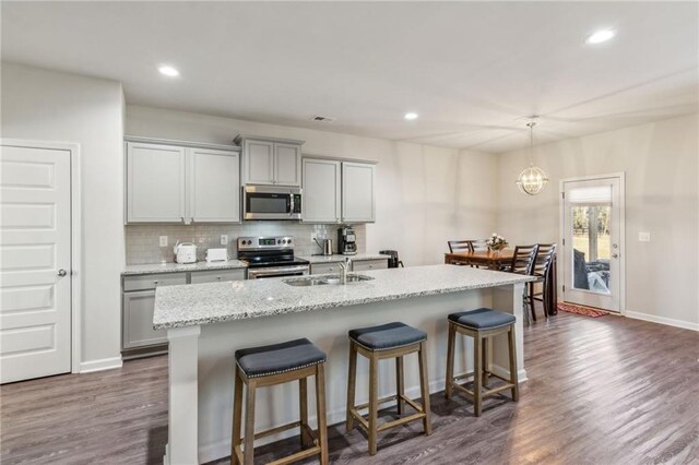 121 Jim Daws, Monroe, GA 30655 - kitchen featuring an island with sink, appliances with stainless steel finishes, gray cabinets, and a breakfast bar area