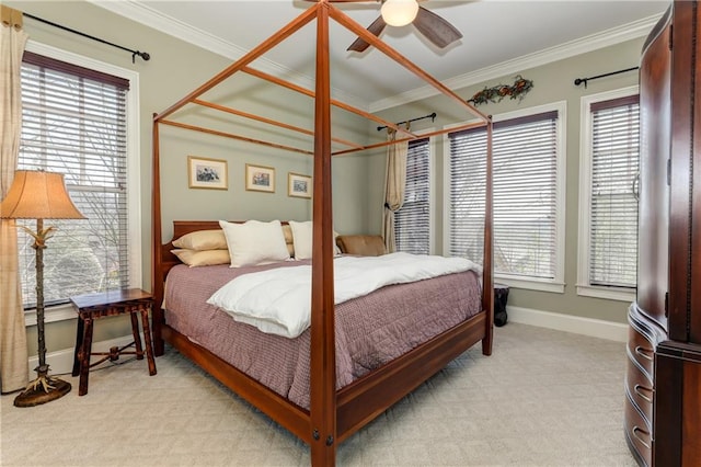 carpeted bedroom with ceiling fan and ornamental molding