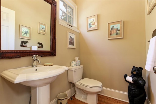 bathroom with sink, hardwood / wood-style flooring, and toilet