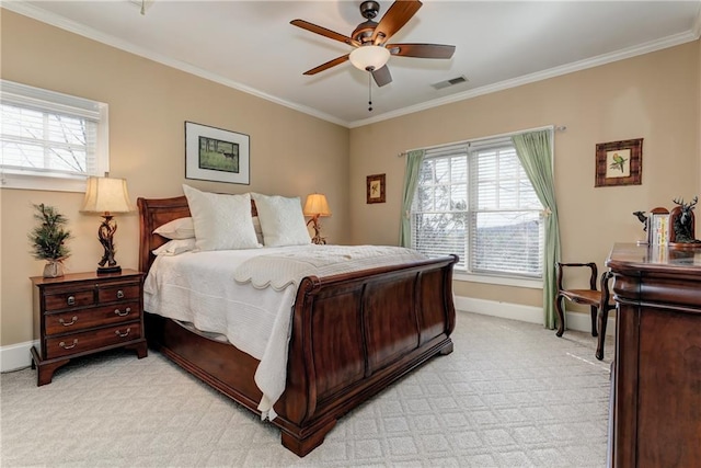 bedroom featuring ceiling fan, ornamental molding, multiple windows, and light colored carpet