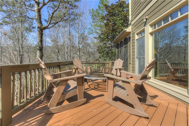 wooden terrace with a fire pit