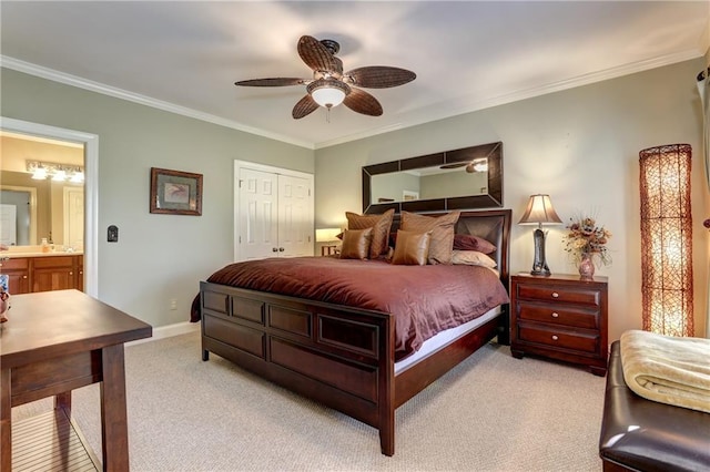 carpeted bedroom featuring a closet, ceiling fan, ornamental molding, and ensuite bath