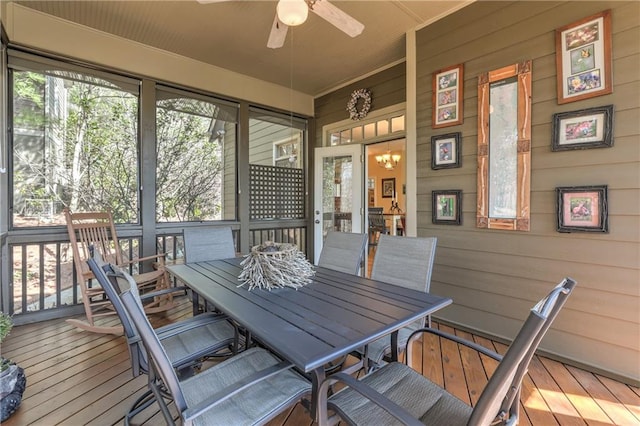 sunroom featuring ceiling fan