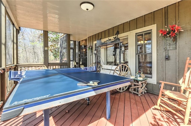 recreation room featuring wooden walls and hardwood / wood-style floors