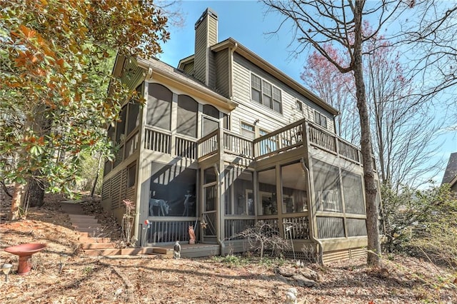 back of house with a sunroom