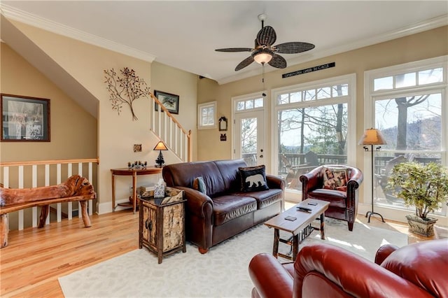 living room with ornamental molding, hardwood / wood-style floors, and ceiling fan