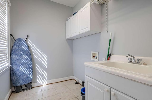 clothes washing area with hookup for a washing machine, plenty of natural light, cabinet space, and a sink