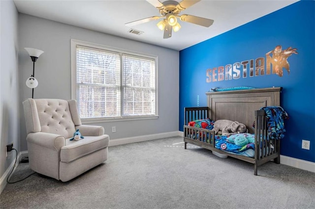 carpeted bedroom featuring a ceiling fan, visible vents, and baseboards