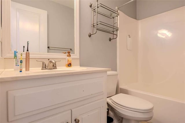 bathroom with vanity, toilet, and shower / bathtub combination