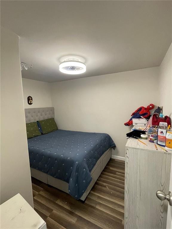 bedroom featuring wood finished floors and baseboards