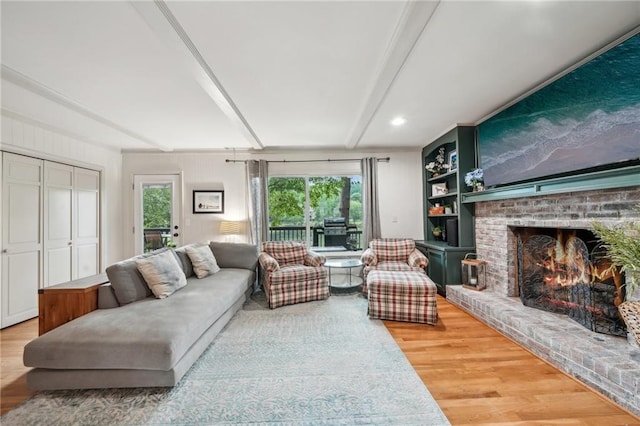 177 Coopers Pond Dr, Lawrenceville, GA 30044 - living room with wood finished floors, beam ceiling, and a fireplace