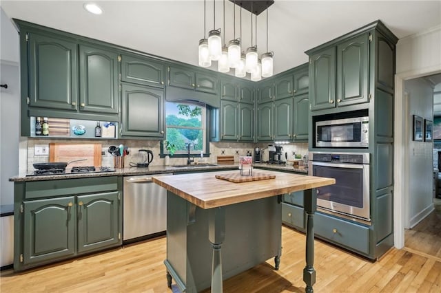 177 Coopers Pond Dr, Lawrenceville, GA 30044 - kitchen featuring appliances with stainless steel finishes, green cabinetry, butcher block counters, and recessed lighting