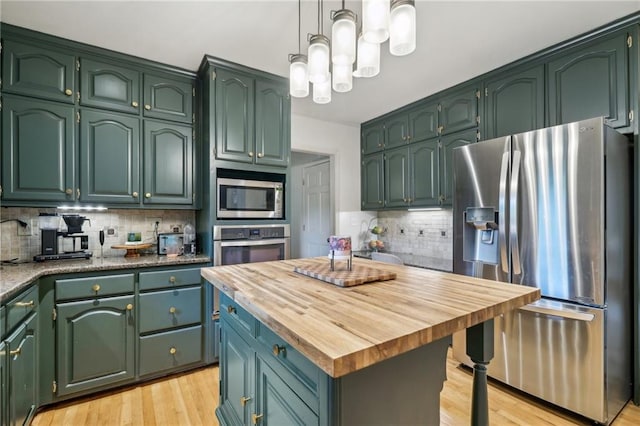 177 Coopers Pond Dr, Lawrenceville, GA 30044 - kitchen featuring stainless steel appliances, backsplash, light wood finished floors, and butcher block counters