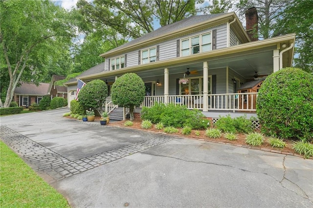 177 Coopers Pond Dr, Lawrenceville, GA 30044 - view of front of home with covered porch, a ceiling fan, and a chimney