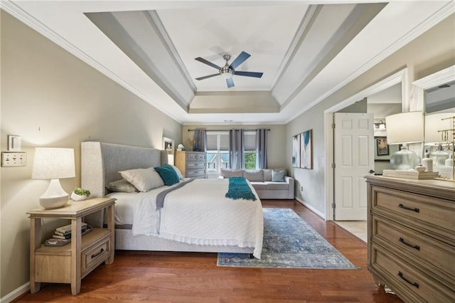 177 Coopers Pond Dr, Lawrenceville, GA 30044 - bedroom featuring a tray ceiling, ornamental molding, baseboards, wood finished floors, and ceiling fan
