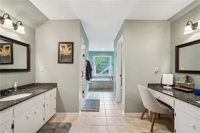 177 Coopers Pond Dr, Lawrenceville, GA 30044 - full bathroom featuring tile patterned floors, baseboards, a garden tub, two vanities, and a shower stall