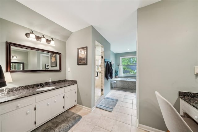 177 Coopers Pond Dr, Lawrenceville, GA 30044 - full bathroom with vanity, tile patterned floors, baseboards, a garden tub, and a stall shower