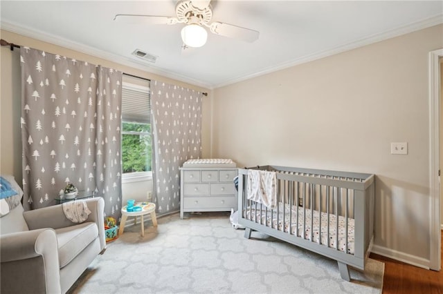 177 Coopers Pond Dr, Lawrenceville, GA 30044 - bedroom featuring ornamental molding, a nursery area, ceiling fan, and baseboards