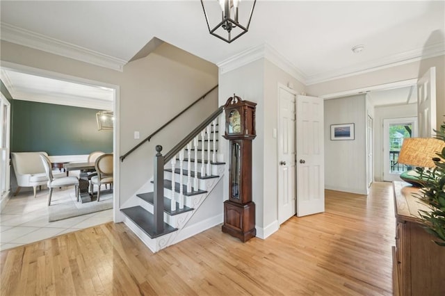177 Coopers Pond Dr, Lawrenceville, GA 30044 - stairway featuring ornamental molding, wood finished floors, a chandelier, and baseboards