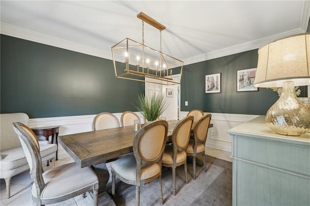 177 Coopers Pond Dr, Lawrenceville, GA 30044 - dining area featuring a decorative wall, a chandelier, ornamental molding, and wainscoting