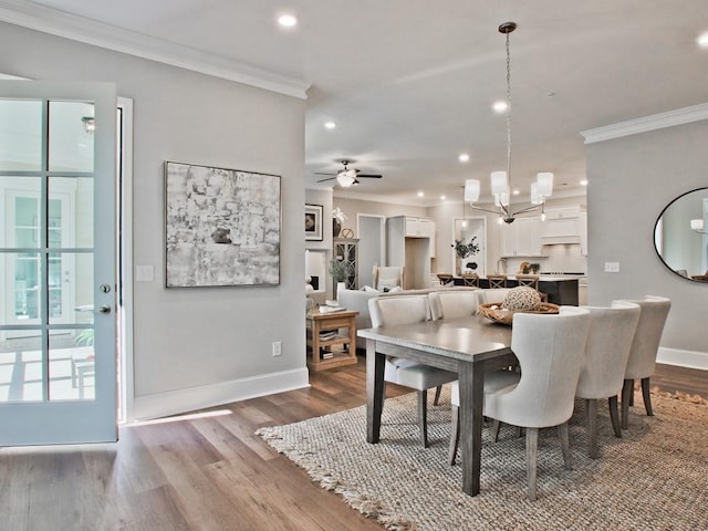 dining room featuring crown molding, recessed lighting, and baseboards