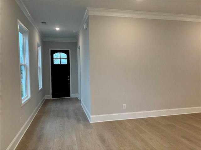 foyer with crown molding, recessed lighting, baseboards, wood finished floors, and visible vents