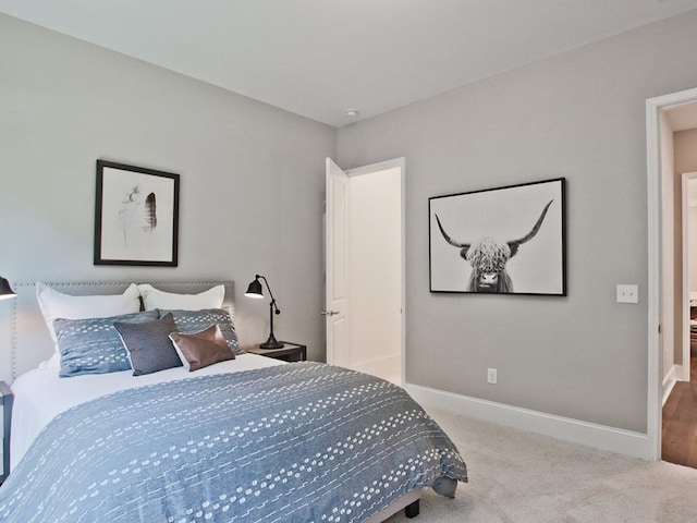 bedroom featuring carpet flooring and baseboards
