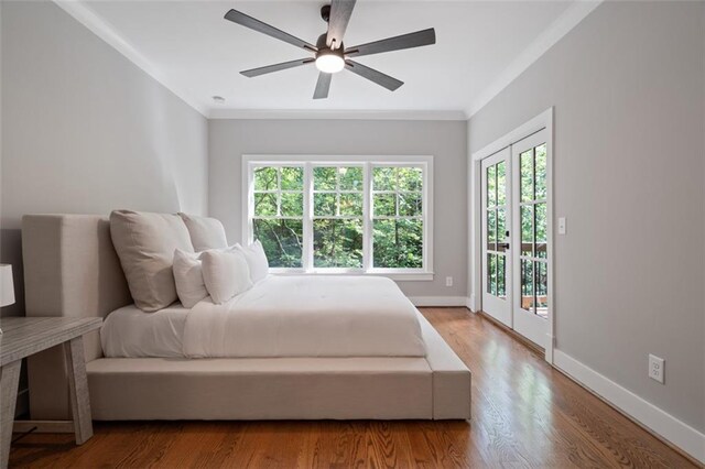 bedroom with access to exterior, french doors, ceiling fan, crown molding, and hardwood / wood-style flooring