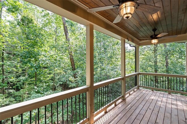 wooden terrace featuring ceiling fan