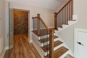 staircase with wood-type flooring