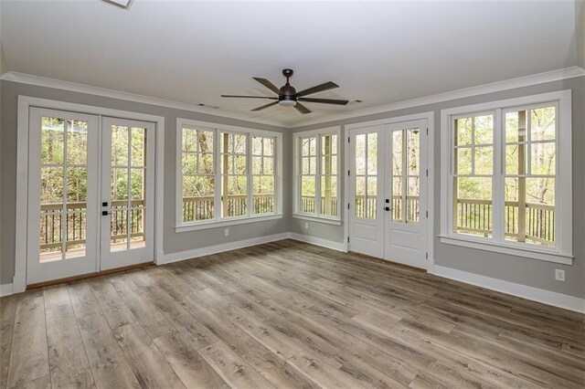 unfurnished sunroom featuring french doors and ceiling fan